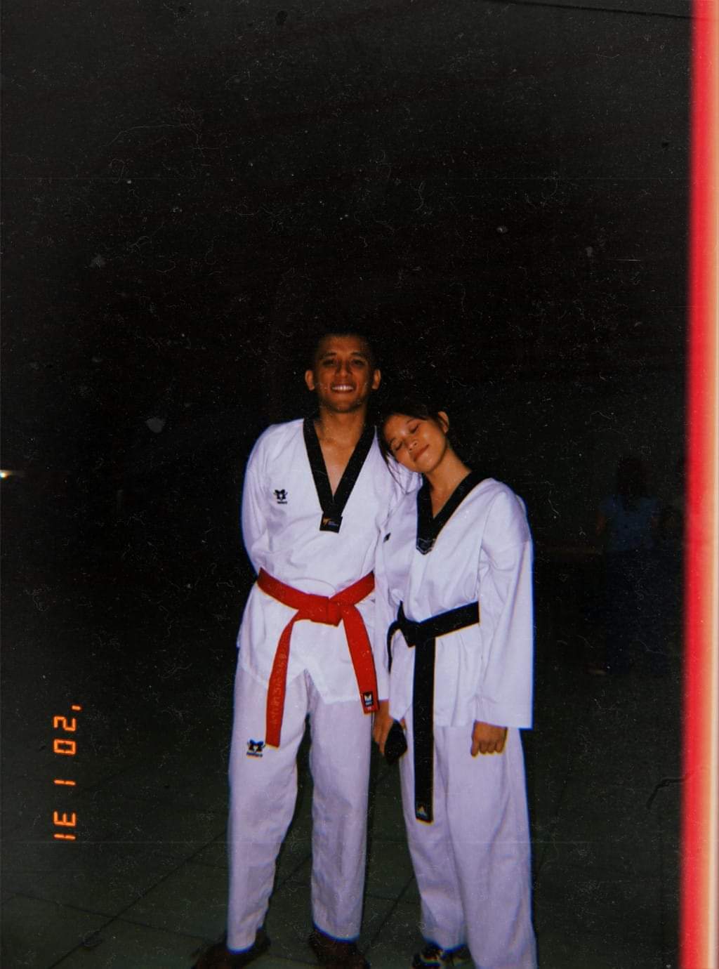 Brenda and Marck together in their taekwondo uniforms