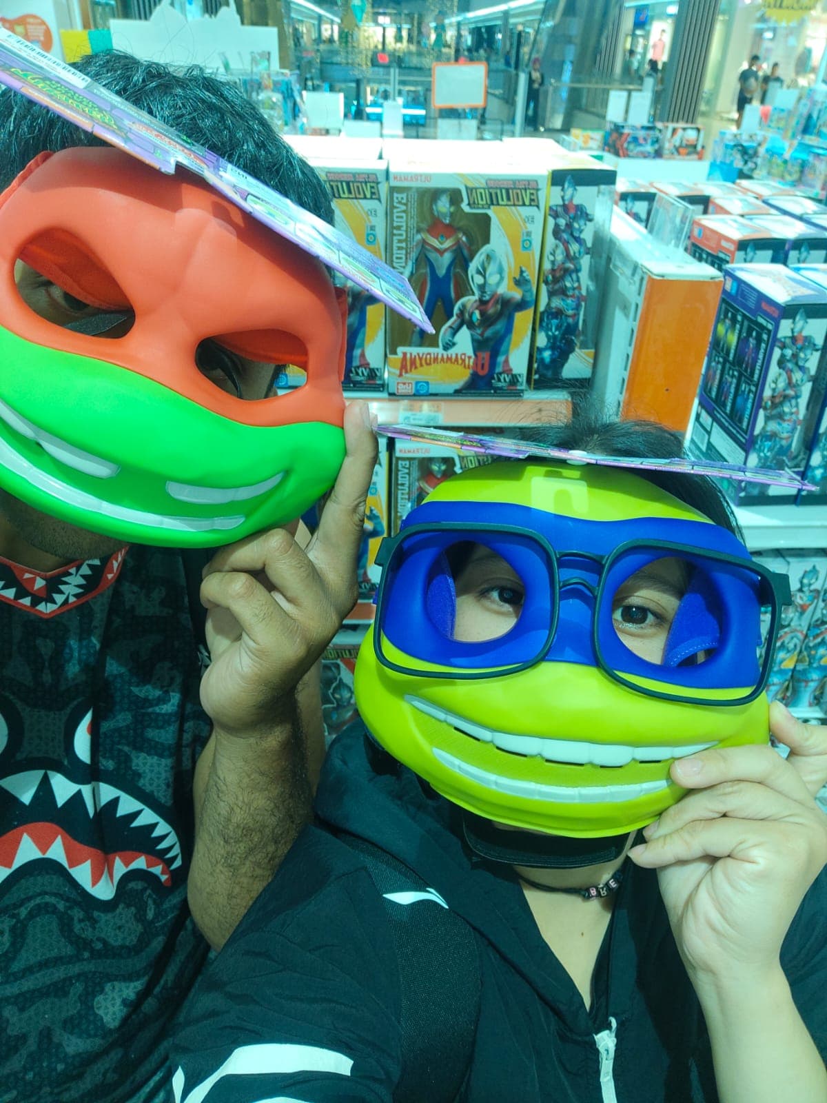 Brenda and Marck sharing a playful moment in a toy shop